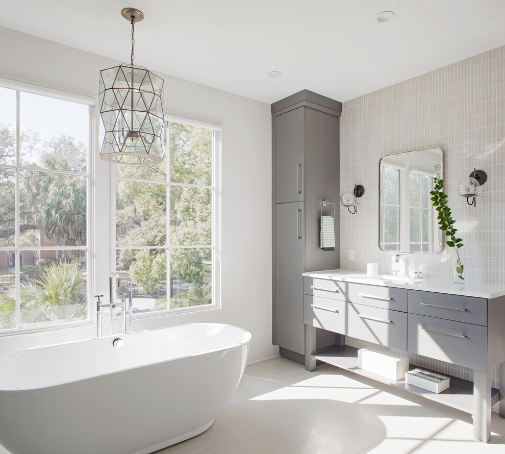 Foto di una stanza da bagno classica di medie dimensioni con ante lisce, ante grigie, vasca freestanding, piastrelle beige, pareti bianche e pavimento bianco