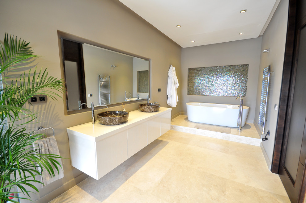 Immagine di una grande stanza da bagno padronale contemporanea con ante lisce, ante bianche, vasca freestanding, vasca/doccia e lavabo a bacinella