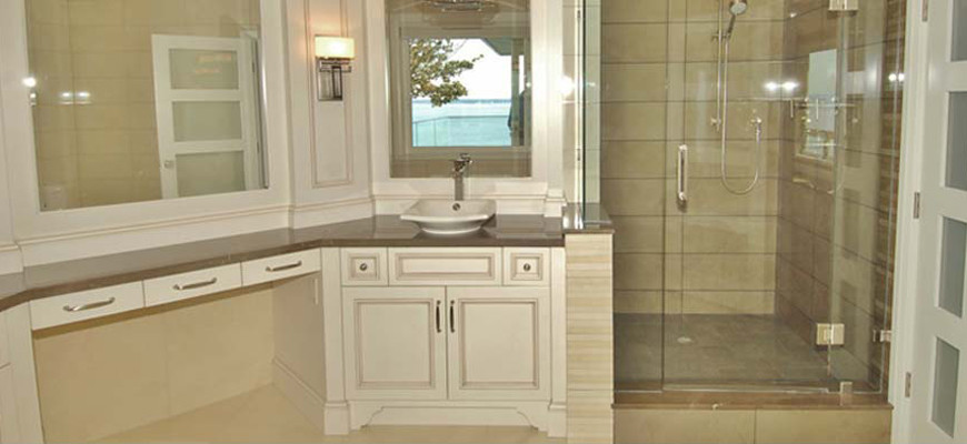 Large trendy beige tile and porcelain tile marble floor bathroom photo in Vancouver with a vessel sink, beaded inset cabinets, distressed cabinets, marble countertops, a one-piece toilet and beige walls