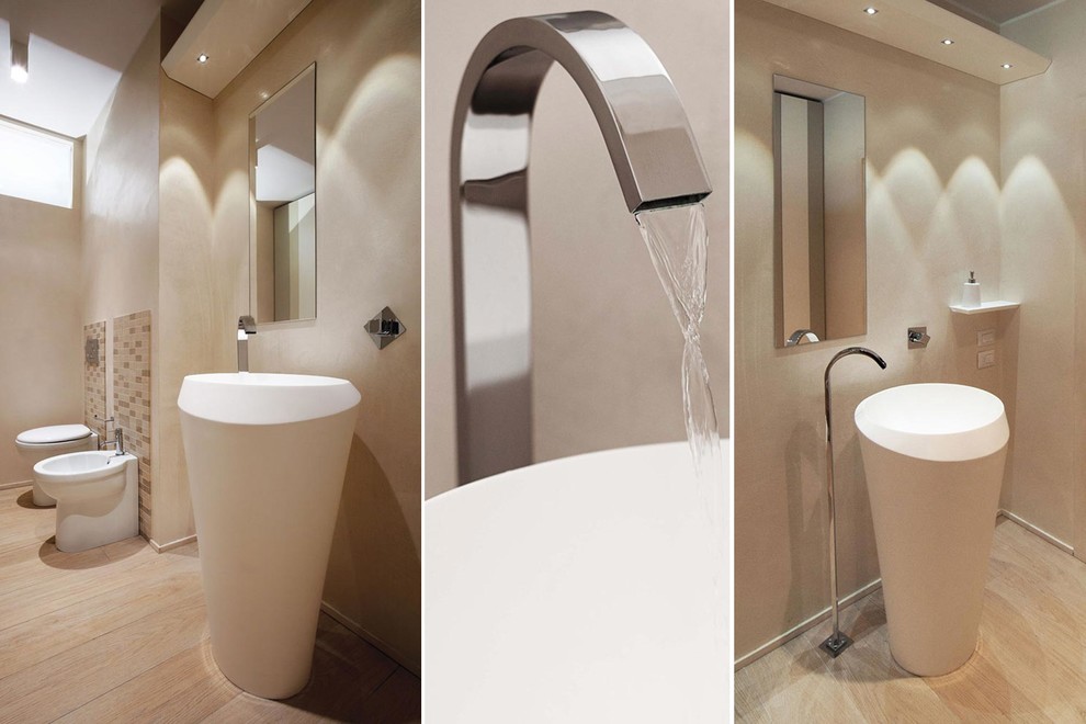 This is an example of a large contemporary ensuite bathroom in Florence with flat-panel cabinets, beige cabinets, a two-piece toilet, beige tiles, beige walls, porcelain flooring, a pedestal sink and engineered stone worktops.