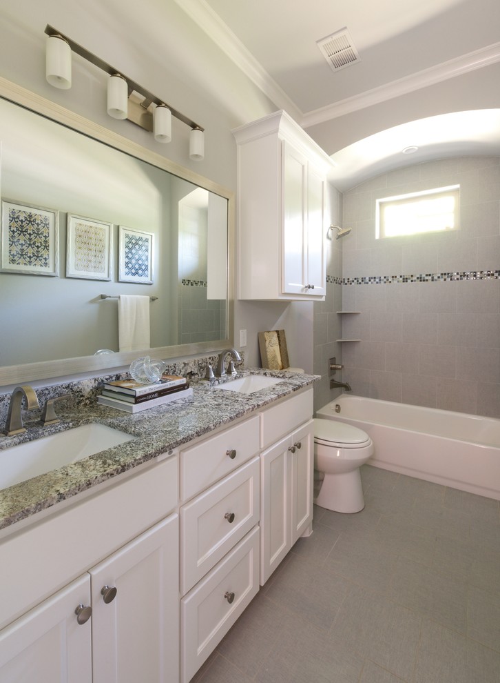 Bathroom - mid-sized transitional gray tile and porcelain tile porcelain tile bathroom idea in Dallas with an undermount sink, shaker cabinets, white cabinets, granite countertops and gray walls