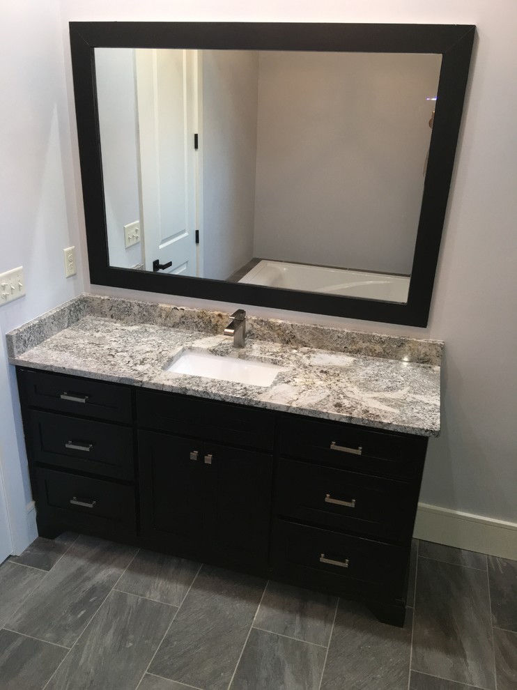Mid-sized transitional master gray tile and ceramic tile ceramic tile bathroom photo in Atlanta with shaker cabinets, black cabinets, gray walls, an undermount sink and granite countertops