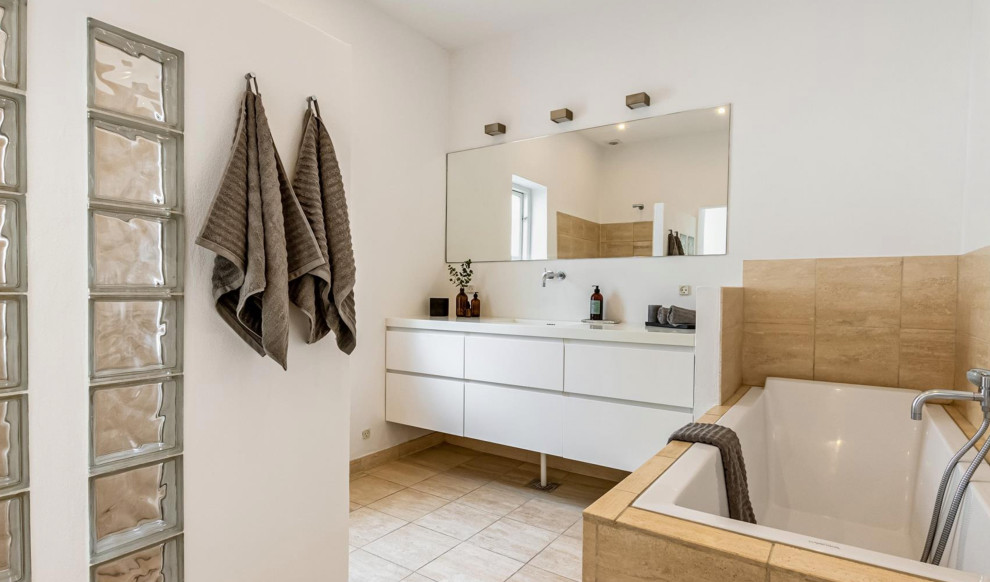 Photo of a medium sized contemporary ensuite bathroom in Copenhagen with flat-panel cabinets, white cabinets, beige tiles, porcelain tiles, white walls, porcelain flooring, a submerged sink, beige floors, white worktops, a single sink and a floating vanity unit.