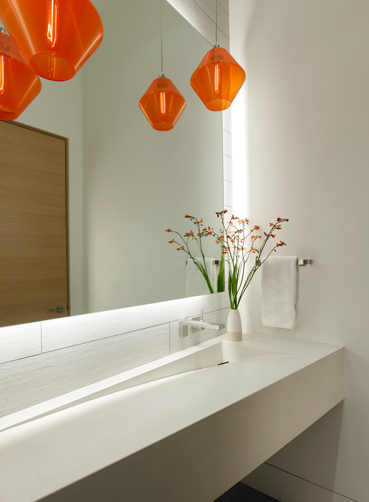 Example of a mid-sized minimalist white tile and porcelain tile porcelain tile and gray floor bathroom design in San Francisco with a wall-mount toilet, white walls, a trough sink, concrete countertops and white countertops