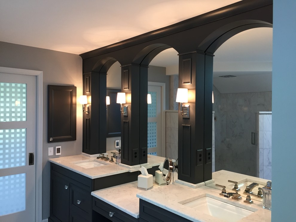 Design ideas for a large traditional ensuite bathroom in Philadelphia with recessed-panel cabinets, blue cabinets, a freestanding bath, a corner shower, porcelain tiles, grey walls, porcelain flooring, a submerged sink and engineered stone worktops.