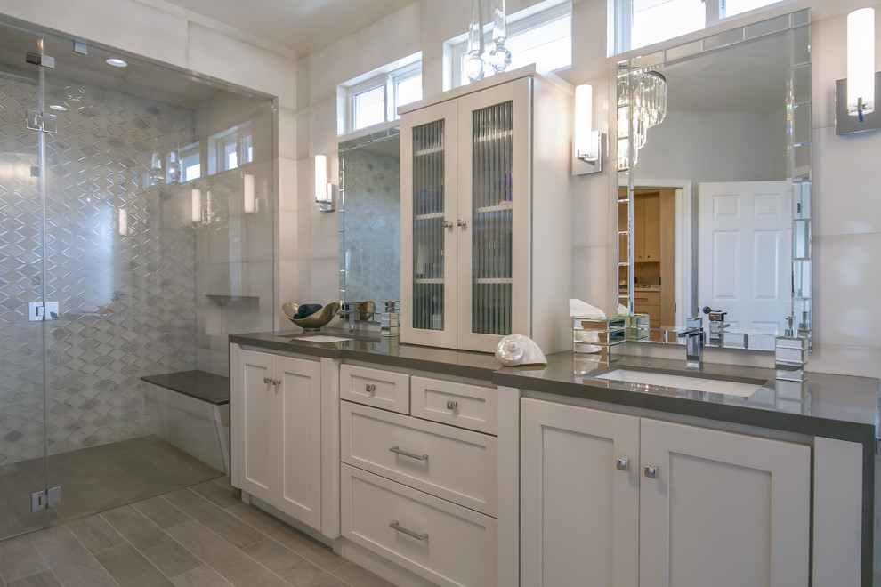 This is an example of a large traditional ensuite bathroom in San Francisco with shaker cabinets, white cabinets, a built-in shower, grey tiles, porcelain tiles, grey walls, porcelain flooring, a built-in sink, engineered stone worktops, beige floors and a hinged door.