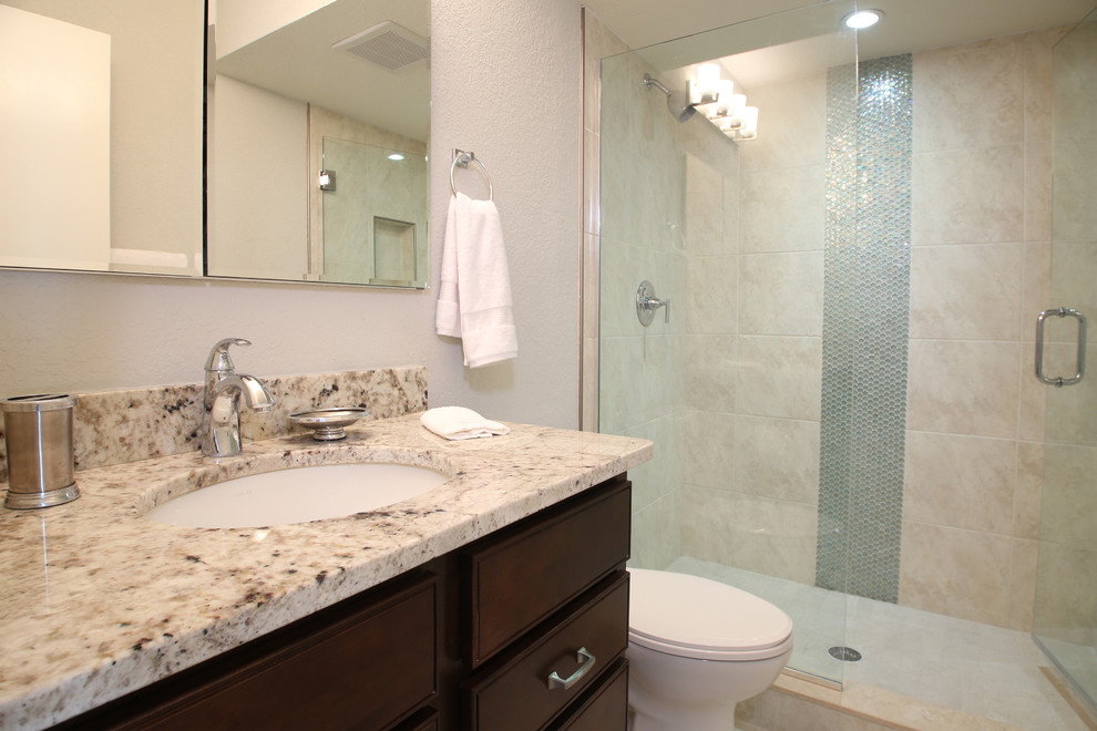 Small beach style beige tile and porcelain tile porcelain tile alcove shower photo in Tampa with an undermount sink, dark wood cabinets, granite countertops, a two-piece toilet and gray walls
