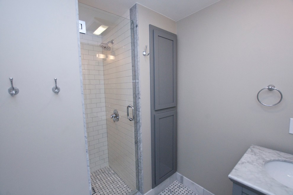 Small ornate 3/4 white tile and subway tile mosaic tile floor alcove shower photo in Other with an undermount sink, shaker cabinets, gray cabinets, marble countertops, a one-piece toilet and gray walls