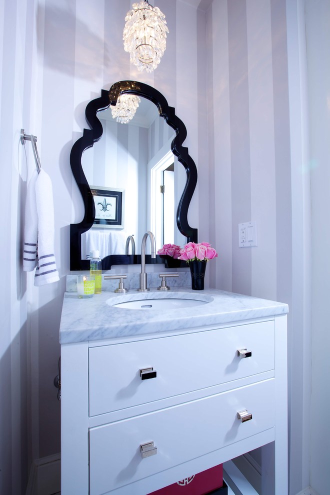 Elegant bathroom photo in Sacramento with marble countertops and an undermount sink
