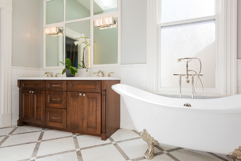 Example of a mid-sized classic master white tile porcelain tile and gray floor bathroom design in San Francisco with flat-panel cabinets, medium tone wood cabinets, white walls, an undermount sink and white countertops