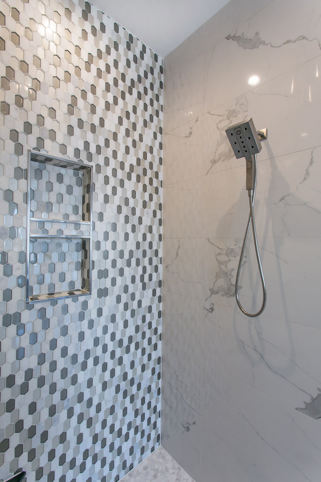 Photo of a large contemporary ensuite bathroom in Seattle with shaker cabinets, black cabinets, a freestanding bath, a walk-in shower, a two-piece toilet, multi-coloured tiles, glass tiles, marble flooring, a submerged sink, engineered stone worktops, white floors, an open shower and grey walls.
