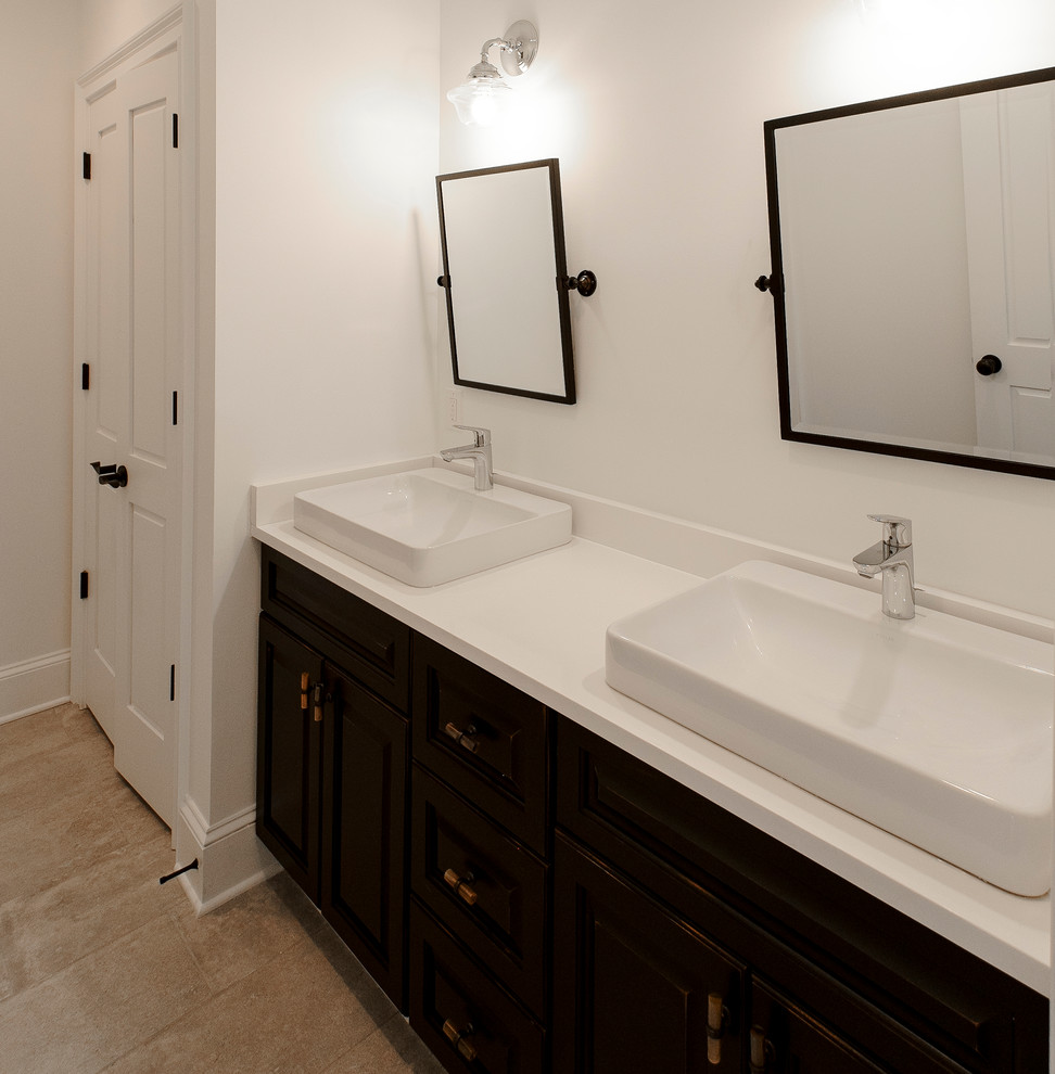 Medium sized mediterranean family bathroom in Other with recessed-panel cabinets, black cabinets, a freestanding bath, an alcove shower, a one-piece toilet, beige tiles, porcelain tiles, white walls, ceramic flooring, a vessel sink and onyx worktops.