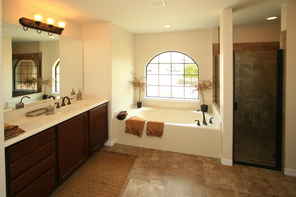 Bathroom - mid-sized traditional master beige tile, brown tile and stone tile travertine floor bathroom idea in Orlando with recessed-panel cabinets, medium tone wood cabinets, white walls, a drop-in sink and marble countertops