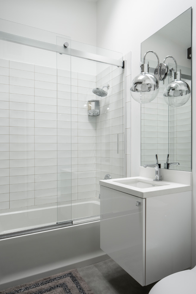 Example of a small 1960s 3/4 white tile and ceramic tile cement tile floor and gray floor bathroom design in Other with flat-panel cabinets, white cabinets, a one-piece toilet, gray walls, an undermount sink, quartz countertops and white countertops