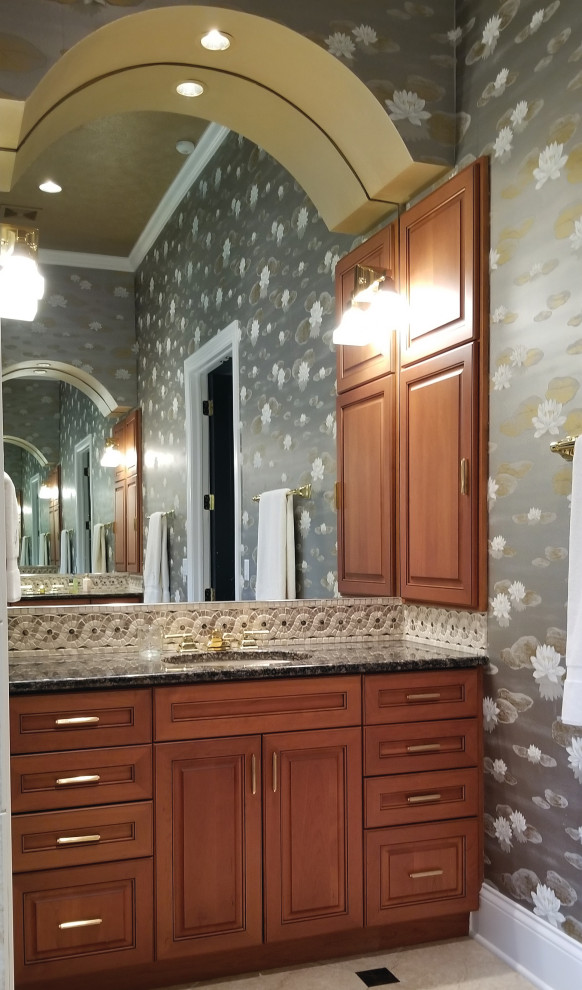 Photo of a large traditional ensuite bathroom in Milwaukee with beaded cabinets, brown cabinets, ceramic tiles, grey walls, ceramic flooring, a submerged sink, granite worktops, beige floors and grey worktops.