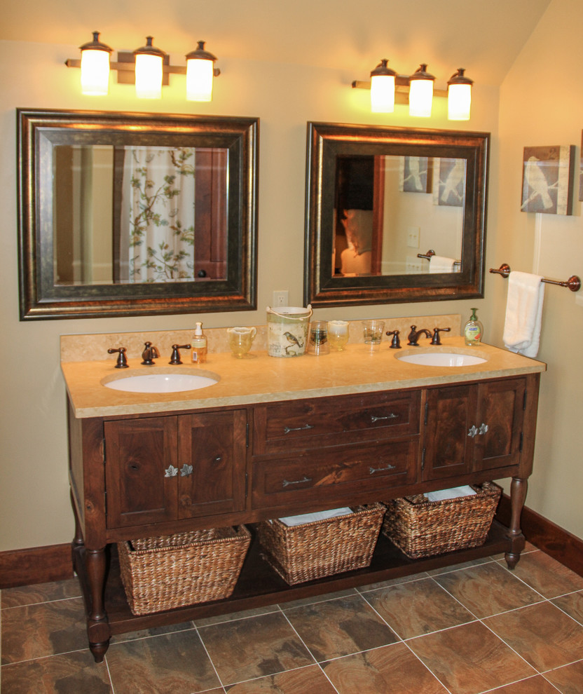 Inspiration for a large rustic 3/4 multicolored tile and stone tile slate floor alcove shower remodel in Charlotte with an undermount sink, furniture-like cabinets, dark wood cabinets, granite countertops, a two-piece toilet and beige walls