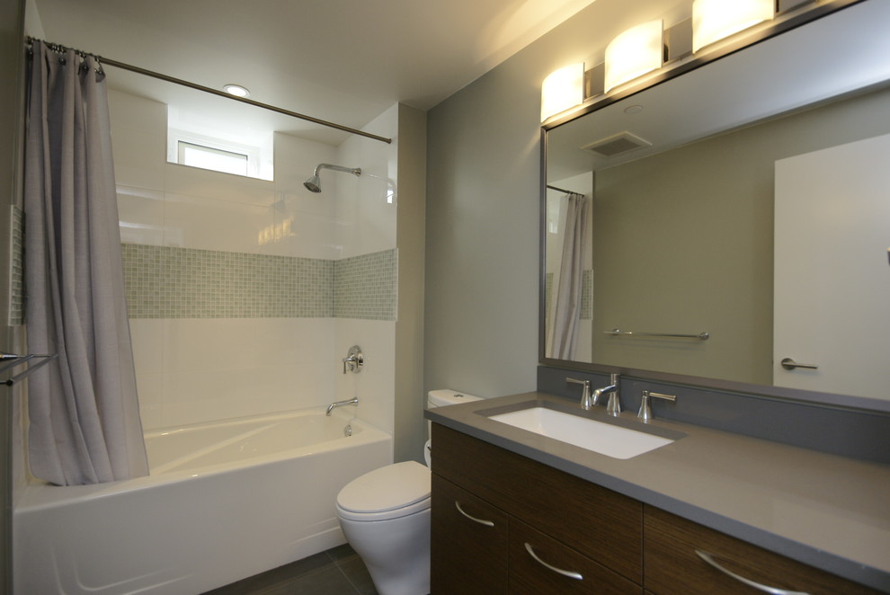 Inspiration for a small contemporary shower room bathroom in Vancouver with a submerged sink, flat-panel cabinets, medium wood cabinets, quartz worktops, an alcove bath, green tiles, an alcove shower, a two-piece toilet, porcelain tiles, grey walls, ceramic flooring, a shower curtain and grey worktops.