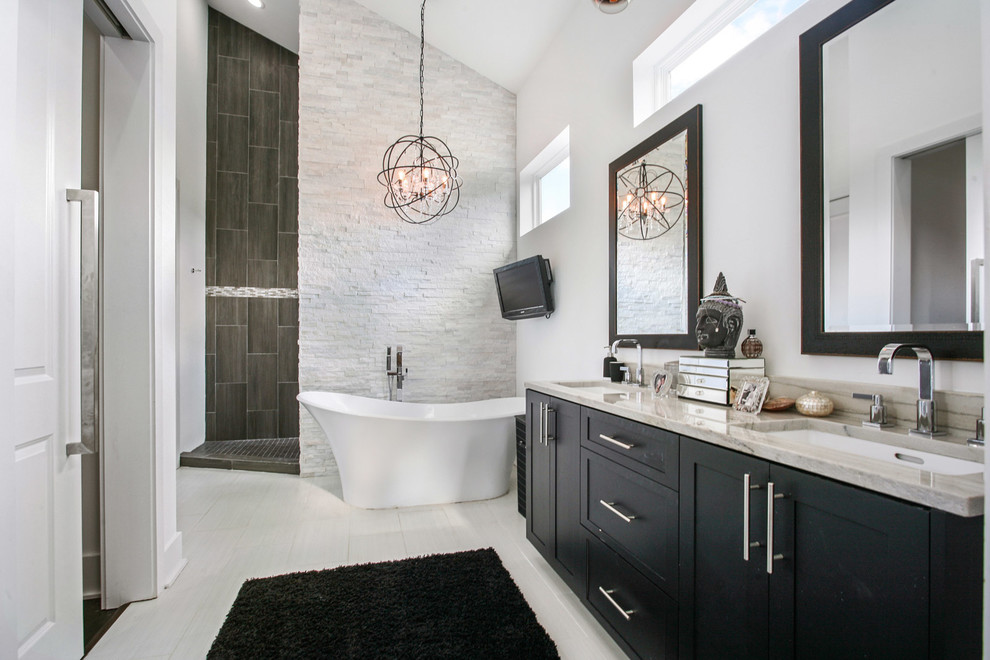This is an example of a classic ensuite bathroom in New Orleans with shaker cabinets, dark wood cabinets, a freestanding bath, white walls, a submerged sink and an open shower.