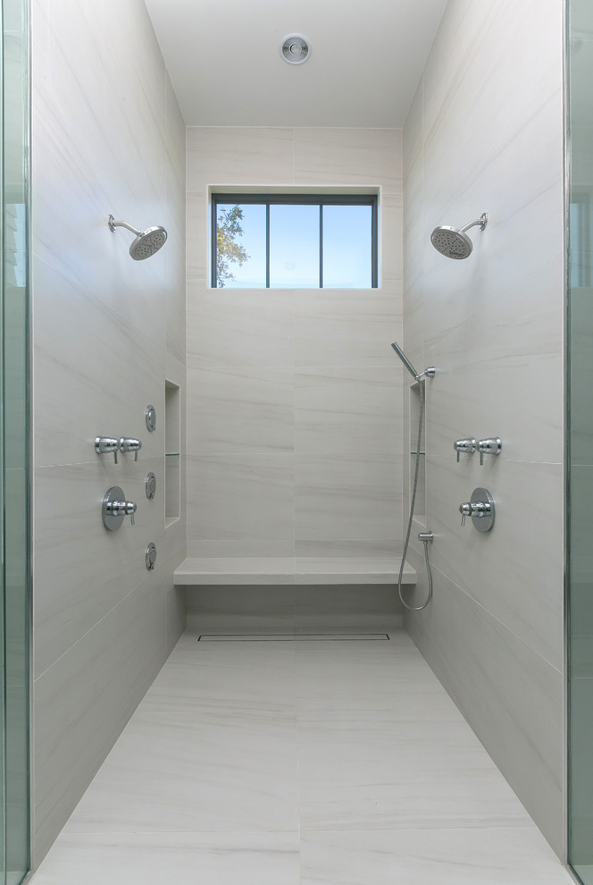 Photo of a large modern ensuite bathroom in Charleston with flat-panel cabinets, grey cabinets, a walk-in shower, a one-piece toilet, white tiles, porcelain tiles, multi-coloured walls, porcelain flooring, a submerged sink, marble worktops, multi-coloured floors and a hinged door.