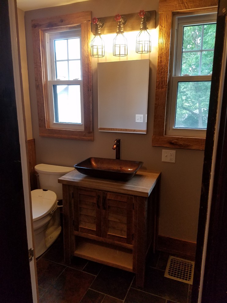 Bathroom - small rustic 3/4 multicolored tile and slate tile slate floor and multicolored floor bathroom idea in Cincinnati with louvered cabinets, light wood cabinets, a bidet, beige walls, a vessel sink and wood countertops