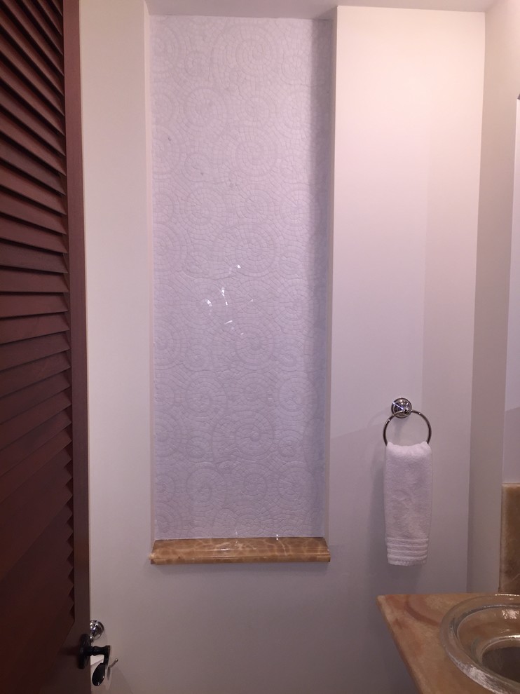ハワイにある小さなトロピカルスタイルのおしゃれなバスルーム (浴槽なし) (オニキスの洗面台、白いタイル) の写真