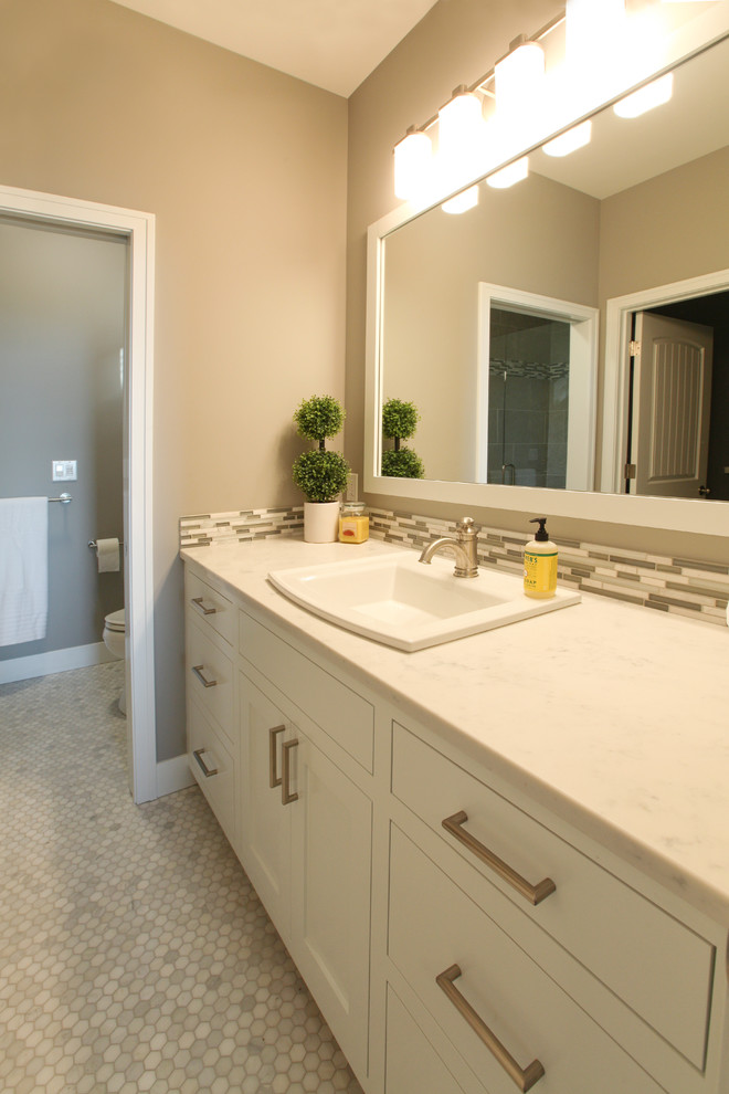 This is an example of a medium sized nautical ensuite bathroom in Grand Rapids with shaker cabinets, white cabinets, quartz worktops, white tiles, mosaic tiles, grey walls and mosaic tile flooring.