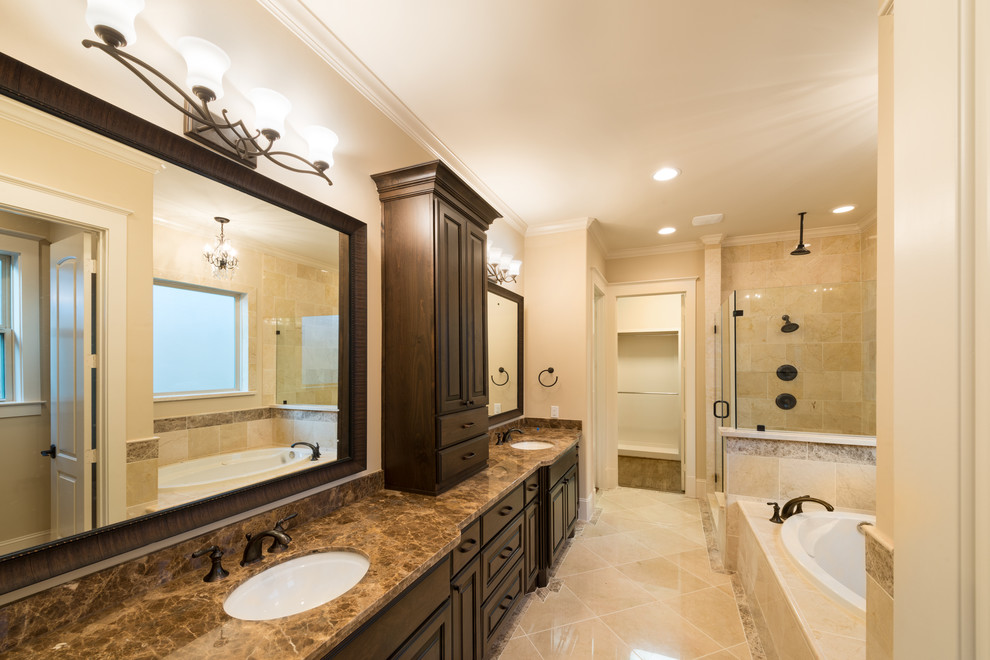 Inspiration for a large timeless master beige tile and porcelain tile porcelain tile bathroom remodel in Houston with raised-panel cabinets, dark wood cabinets, beige walls and an undermount sink