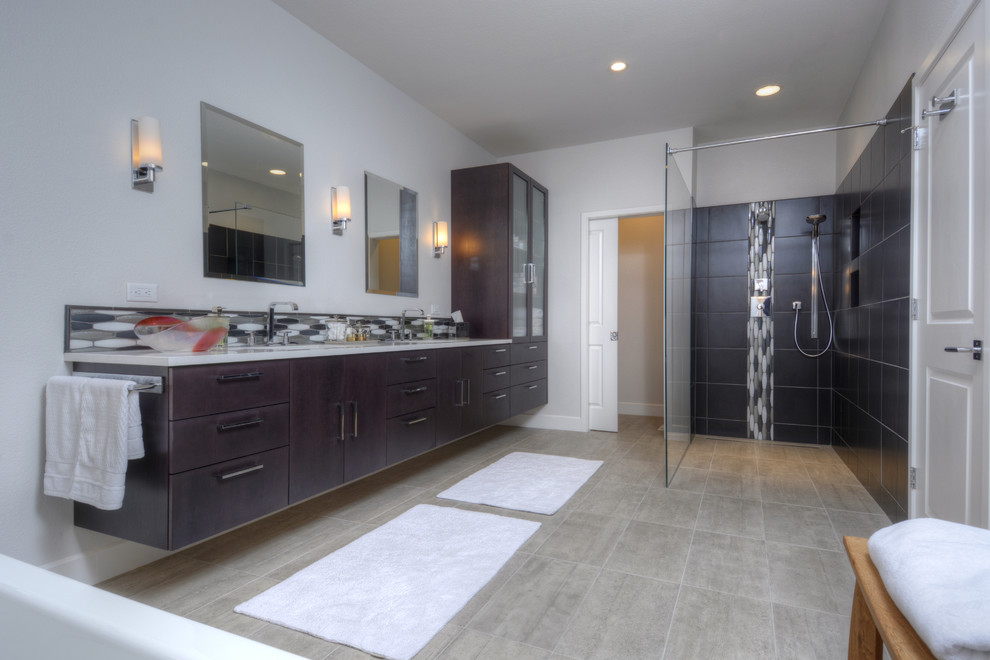 Example of a large trendy master gray tile and porcelain tile porcelain tile bathroom design in Denver with an undermount sink, flat-panel cabinets, dark wood cabinets, quartz countertops, a two-piece toilet and gray walls