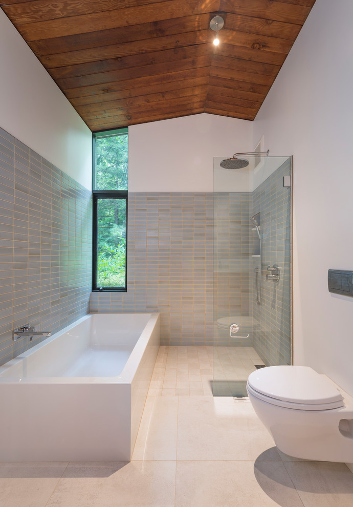 Medium sized midcentury ensuite bathroom in Boston with flat-panel cabinets, light wood cabinets, a corner bath, a built-in shower, a wall mounted toilet, blue tiles, green tiles, ceramic tiles, white walls, porcelain flooring, a submerged sink, engineered stone worktops, beige floors, an open shower and white worktops.