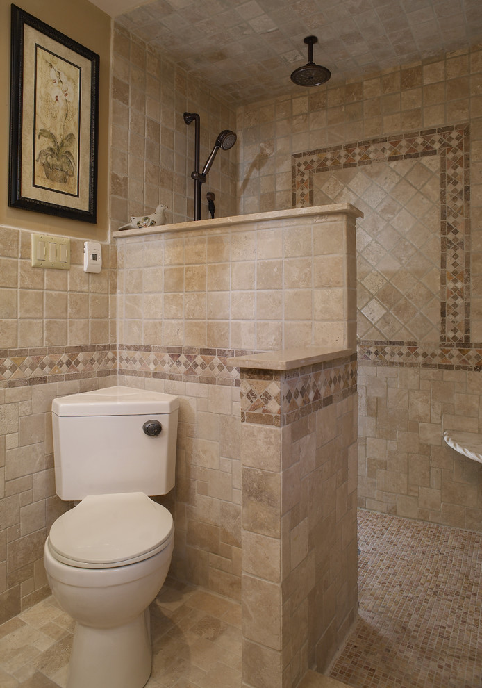 Mediterranean bathroom in Philadelphia with a two-piece toilet, beige tiles and stone tiles.