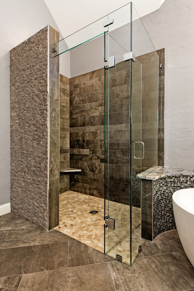 Inspiration for a traditional ensuite bathroom in Dallas with recessed-panel cabinets, brown cabinets, a freestanding bath, a built-in shower, brown tiles, porcelain tiles, grey walls, porcelain flooring, granite worktops and a submerged sink.