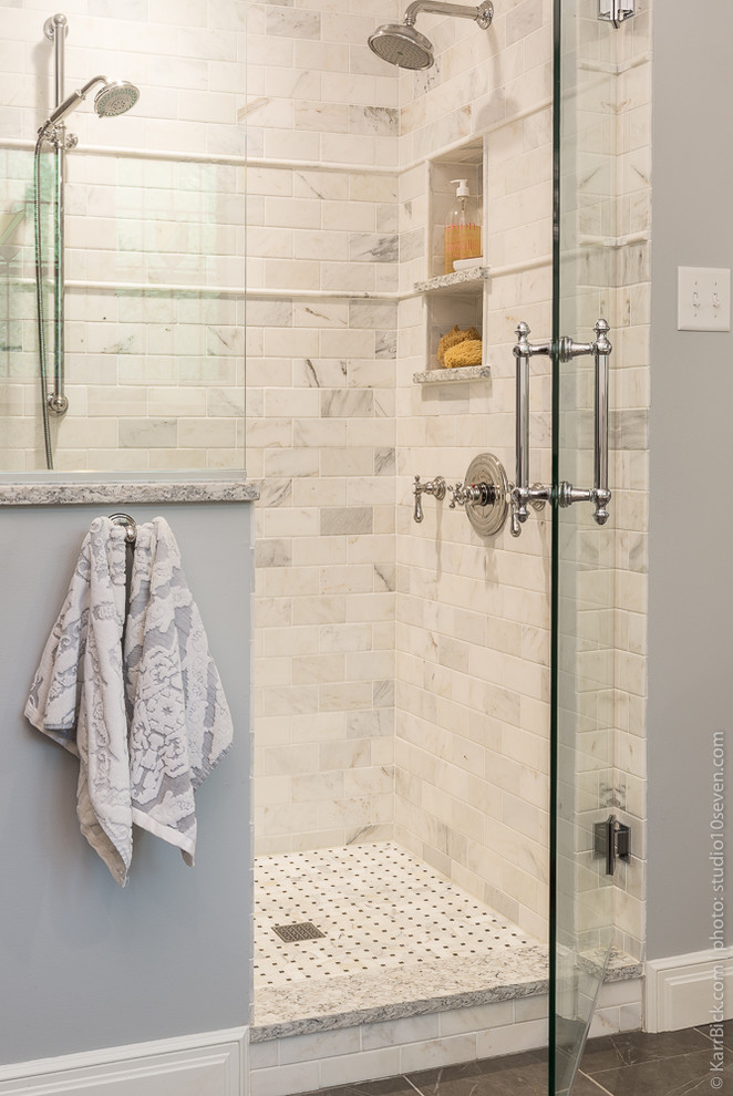 This is an example of a medium sized classic ensuite bathroom in St Louis with freestanding cabinets, white cabinets, a freestanding bath, a walk-in shower, white tiles, metro tiles, grey walls, porcelain flooring and a console sink.