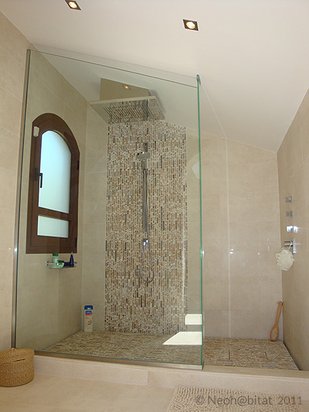 Corner shower - mid-sized contemporary master beige tile and porcelain tile marble floor and beige floor corner shower idea in Other with a console sink, glass-front cabinets, marble countertops, a two-piece toilet, beige walls, white cabinets and a hinged shower door