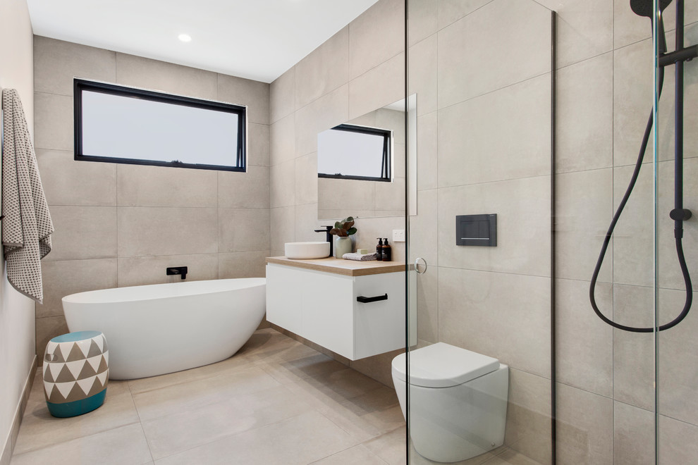 Large contemporary bathroom in Melbourne with freestanding cabinets, white cabinets, a corner shower, a wall mounted toilet, grey tiles, porcelain tiles, grey walls, porcelain flooring, laminate worktops, grey floors, a hinged door and beige worktops.