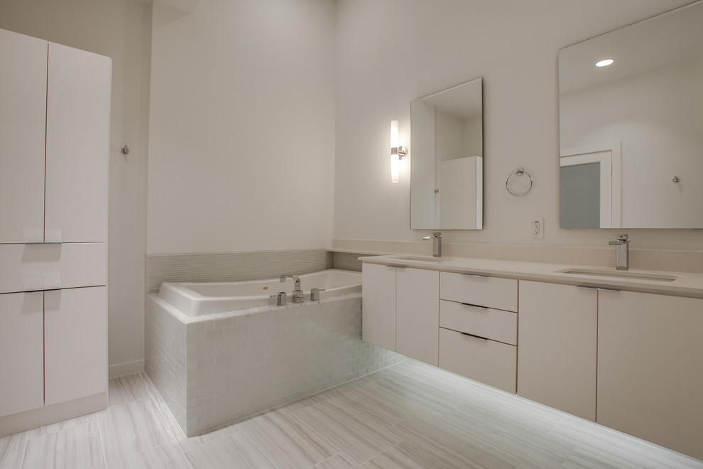 Example of a large 1950s master white tile and glass tile porcelain tile bathroom design in Dallas with an undermount sink, flat-panel cabinets, white cabinets, quartzite countertops and white walls