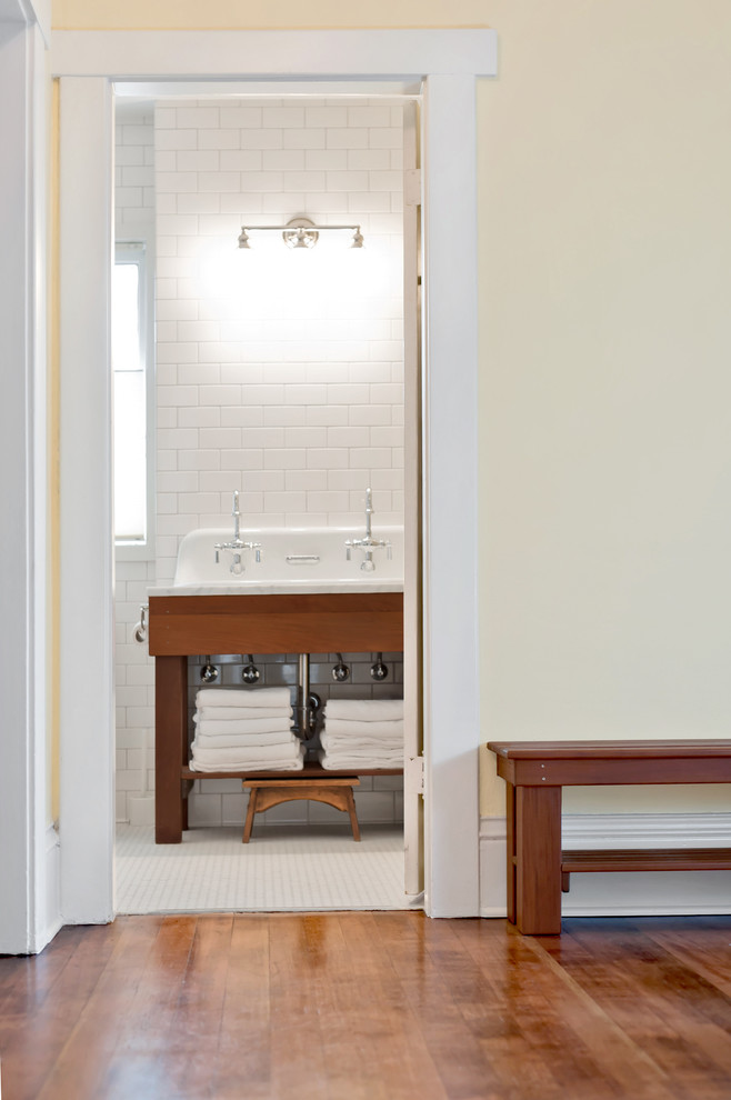 Example of a mid-sized farmhouse master white tile and subway tile dark wood floor and brown floor alcove shower design in Seattle with open cabinets, dark wood cabinets, yellow walls, a trough sink, marble countertops and gray countertops