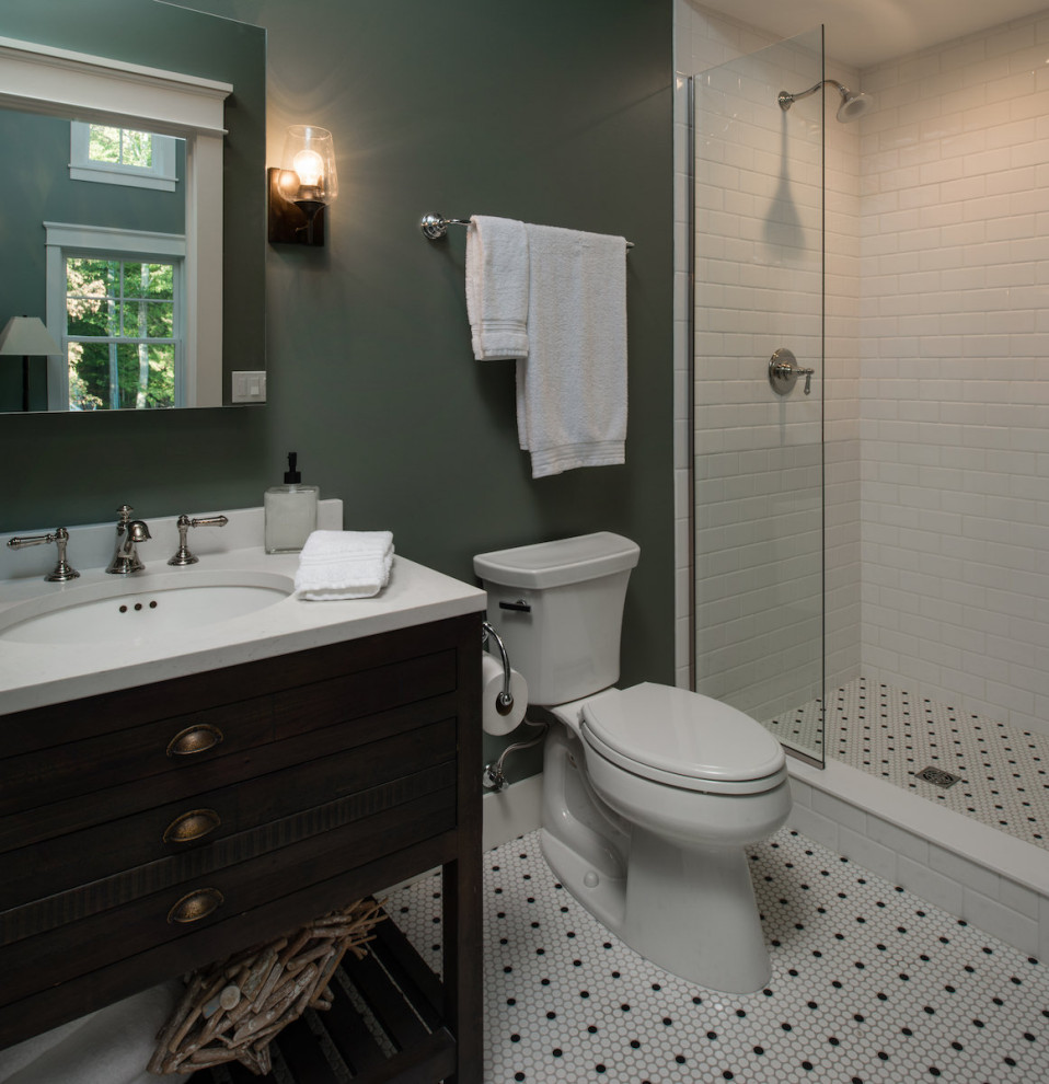 This is an example of a nautical bathroom in Other with freestanding cabinets, dark wood cabinets, an alcove shower, a two-piece toilet, white tiles, metro tiles, green walls, porcelain flooring, a submerged sink, marble worktops, white floors, an open shower and white worktops.