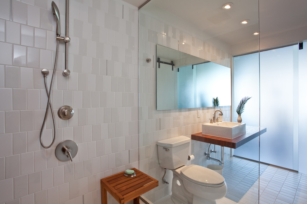 На фото: ванная комната в стиле модернизм с настольной раковиной, открытым душем, раздельным унитазом, серой плиткой, керамической плиткой, полом из керамической плитки и открытым душем с