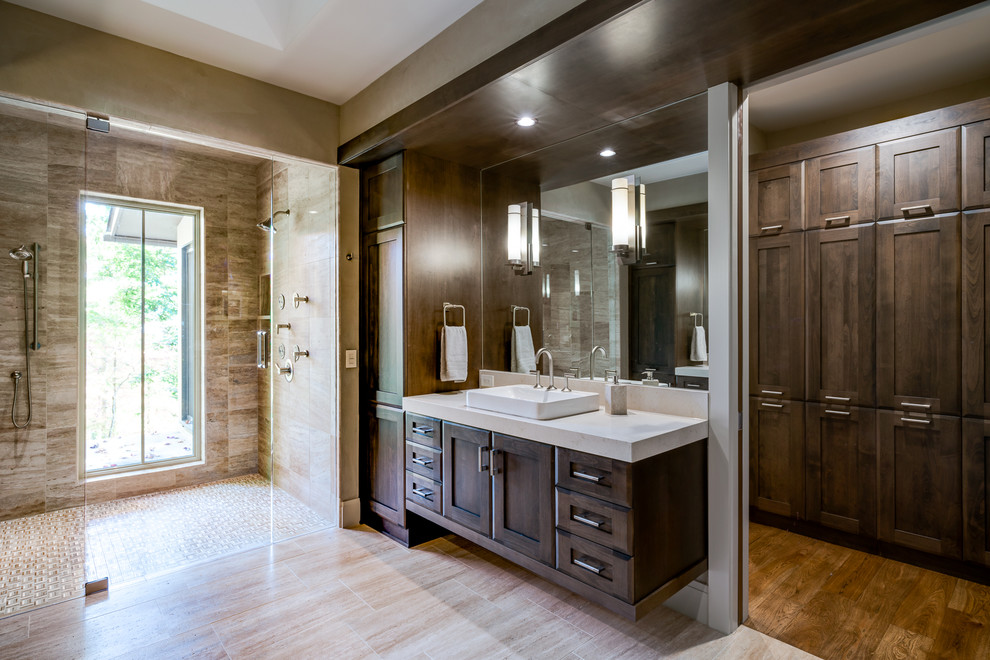 Large classic ensuite bathroom in Other with shaker cabinets, dark wood cabinets, a double shower, a one-piece toilet, beige tiles, stone tiles, beige walls, travertine flooring, a vessel sink and engineered stone worktops.