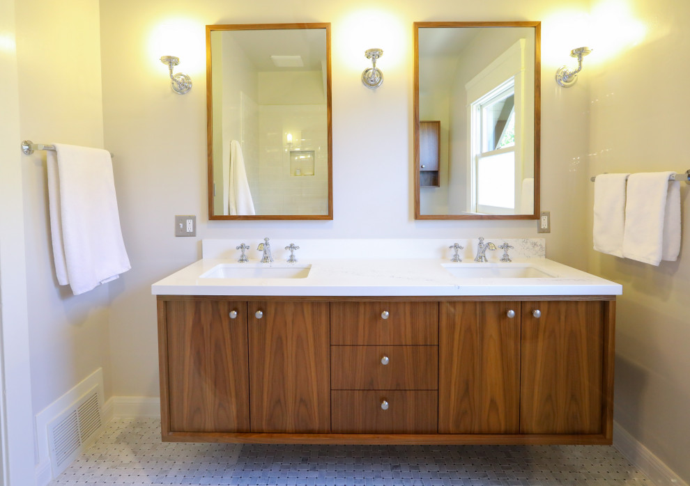 Ispirazione per una stanza da bagno padronale design di medie dimensioni con ante lisce, ante in legno bruno, due lavabi e mobile bagno sospeso