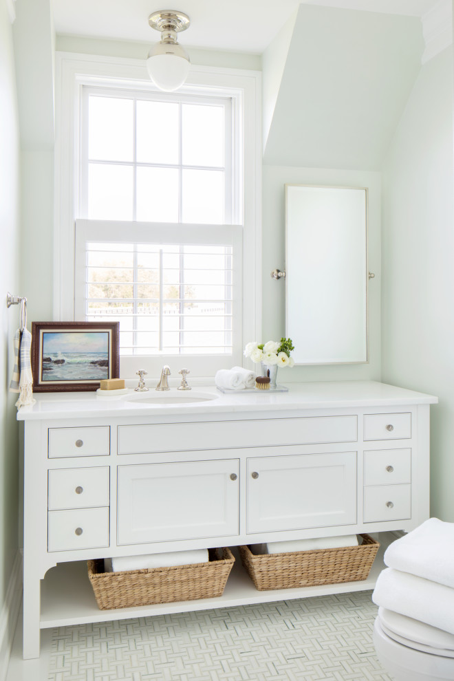 This is an example of a medium sized beach style ensuite bathroom in Richmond with beaded cabinets, white cabinets, a built-in bath, a shower/bath combination, a two-piece toilet, white tiles, metro tiles, green walls, mosaic tile flooring, a submerged sink, quartz worktops, green floors, an open shower and white worktops.