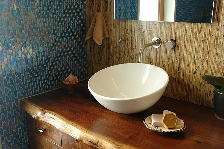 Beach style bathroom photo in Other with a vessel sink and wood countertops