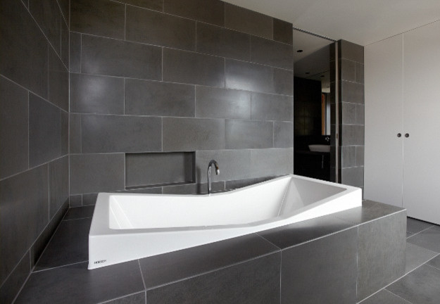 Photo of a small contemporary ensuite bathroom in Melbourne with a built-in bath, grey tiles, stone tiles, black walls and slate flooring.