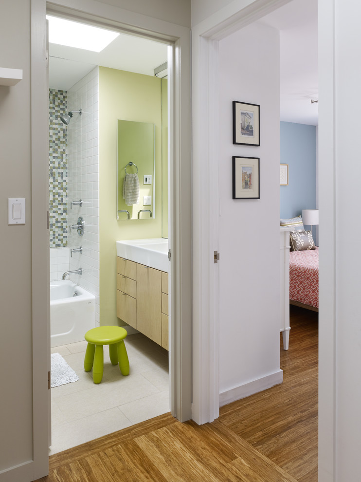 Contemporary bathroom in Philadelphia with flat-panel cabinets, light wood cabinets, green tiles and green walls.