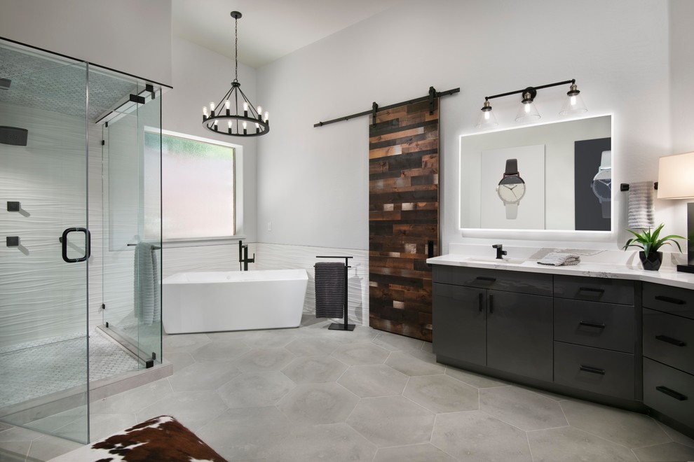 Example of an urban master white tile and porcelain tile cement tile floor and gray floor bathroom design in Phoenix with flat-panel cabinets, gray cabinets, gray walls, an undermount sink, quartz countertops, a hinged shower door and white countertops