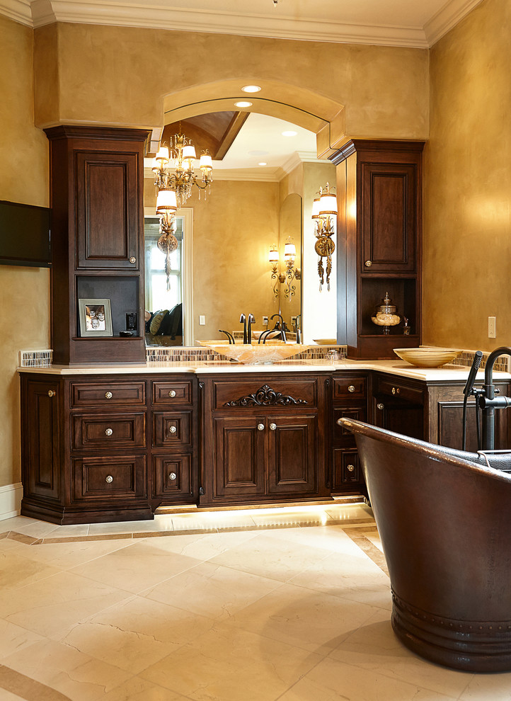 Large traditional ensuite bathroom in Kansas City with a vessel sink, dark wood cabinets, a freestanding bath and beige walls.