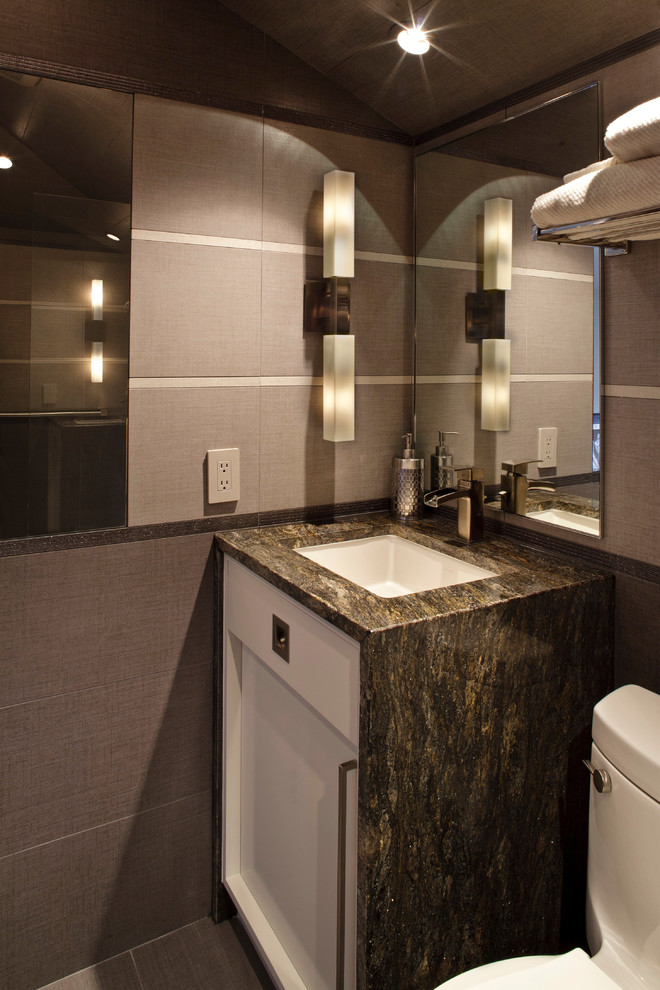 This is an example of a contemporary shower room bathroom in Jacksonville with flat-panel cabinets, white cabinets, grey tiles, porcelain tiles, grey walls, porcelain flooring, a submerged sink and granite worktops.