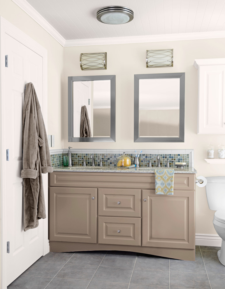 This is an example of a medium sized classic ensuite bathroom in Charlotte with a submerged sink, raised-panel cabinets, grey cabinets, granite worktops, a two-piece toilet, multi-coloured tiles, mosaic tiles, grey walls and ceramic flooring.