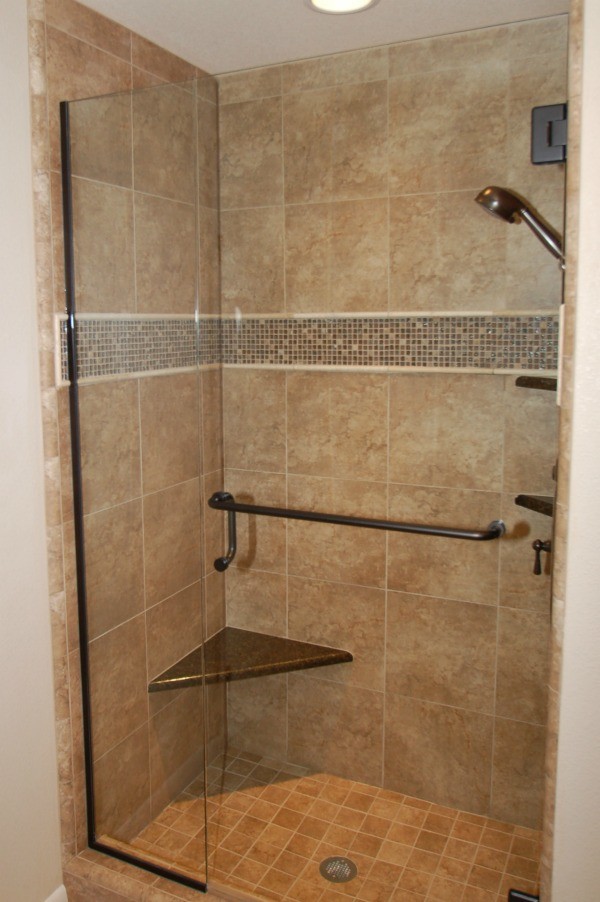 Example of a mid-sized classic master brown tile and ceramic tile ceramic tile bathroom design in Boise with an undermount sink, raised-panel cabinets, medium tone wood cabinets, granite countertops and beige walls