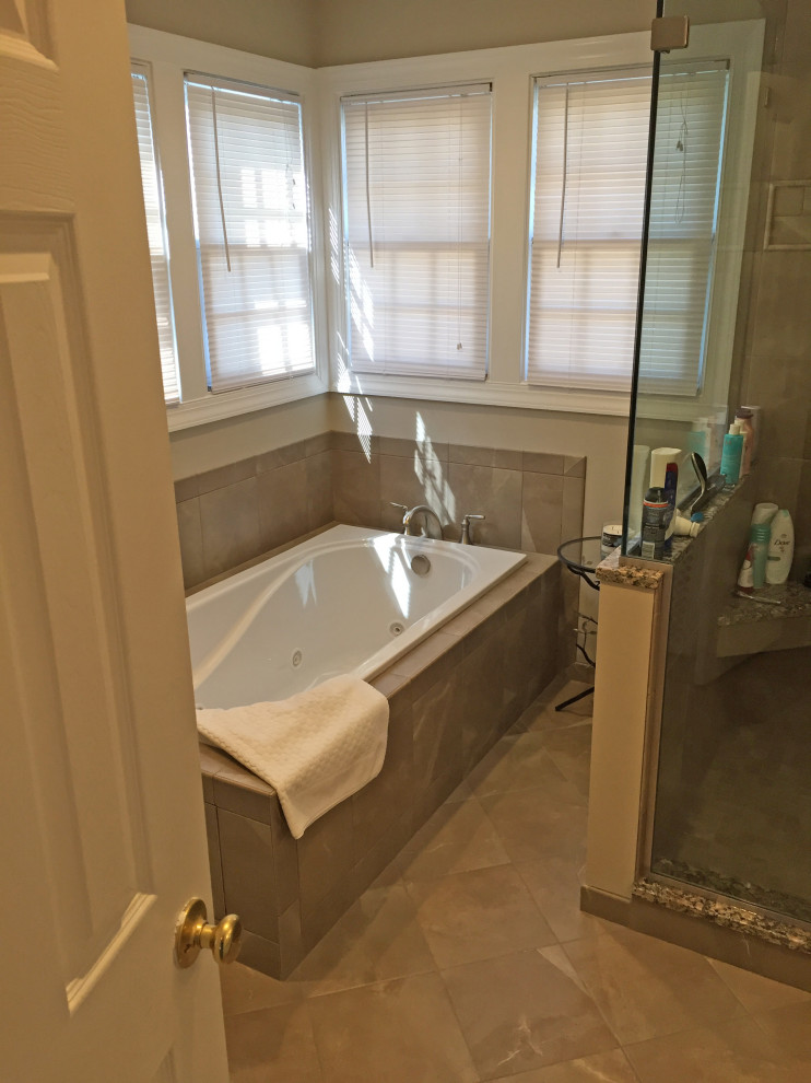 This is an example of a medium sized classic ensuite bathroom in Baltimore with raised-panel cabinets, white cabinets, a built-in bath, an alcove shower, a two-piece toilet, brown tiles, ceramic tiles, beige walls, cement flooring, a submerged sink, engineered stone worktops, brown floors, a hinged door and multi-coloured worktops.